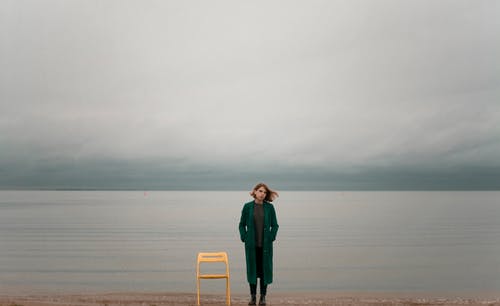 Woman Standing Beside Chair