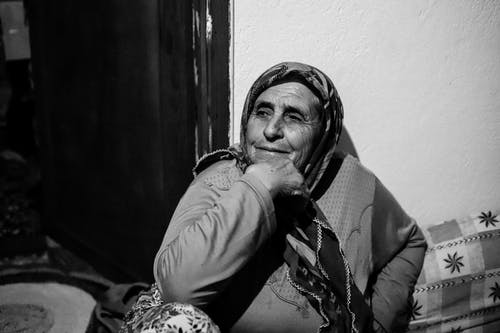 Grayscale Photo of Woman Wearing Headscarf